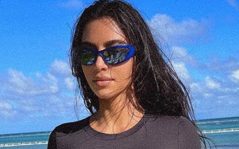 Kim Kardashian Rocks Tight Black Shirt & Bikini Bottoms As She Returns To The Beach