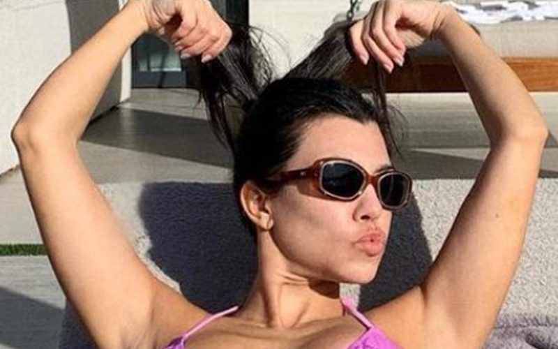 Kourtney Kardashian Soaks Up Sunshine Poolside In Purple Bikini