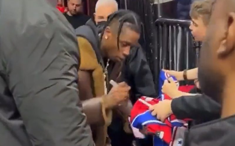 Travis Scott Stops To Sign Autographs For Kids At Philadelphia 76ers Game
