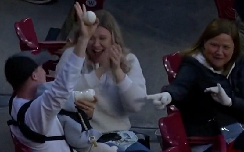 Baseball Fan Effortlessly Snags Foul Ball While Feeding Baby