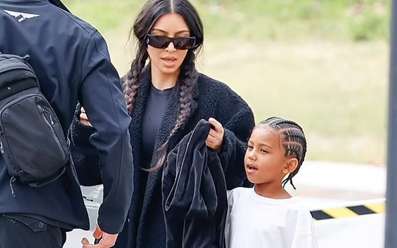 Kim Kardashian Sports Long Black Trench Coat As She Takes Son Saint To A Soccer Game